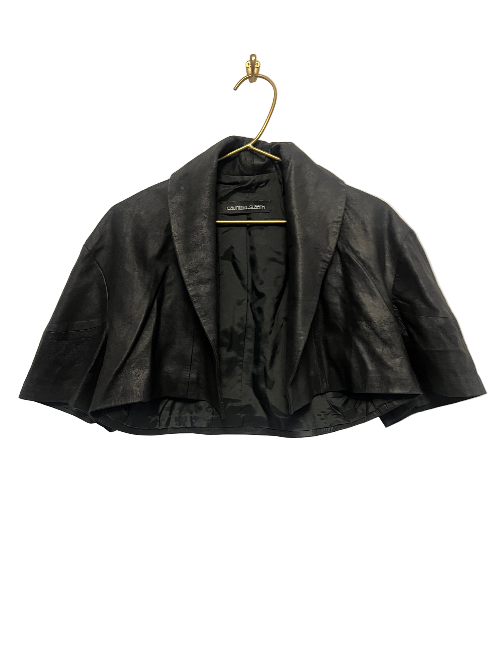 STÆRK black capelet on a beige background