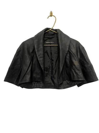 STÆRK black capelet on a beige background