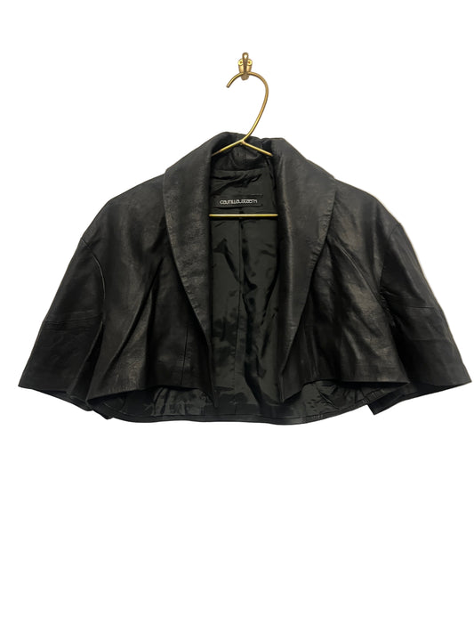 STÆRK black capelet on a beige background